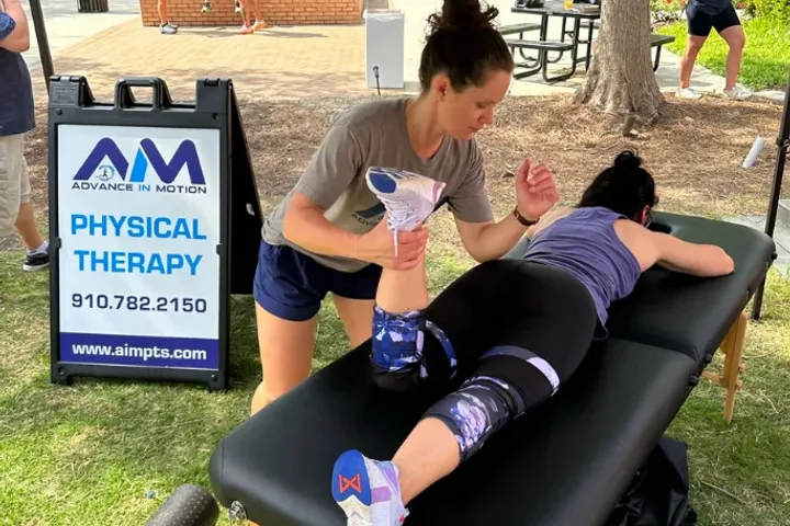An Advance in Motion therapist treating a patient at a community event