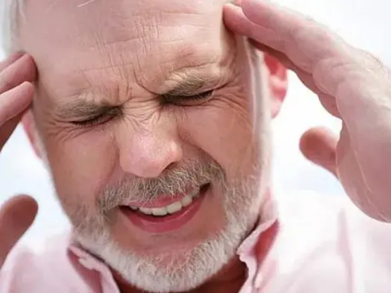 Person holding their temples with a tension headache