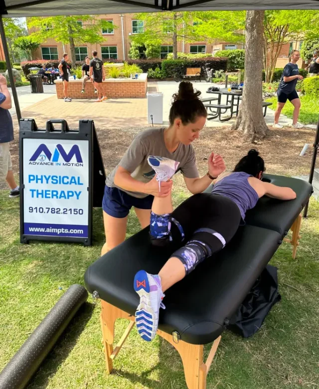 An Advance in Motion physical therapist treating a patient at a community event in Wilmington