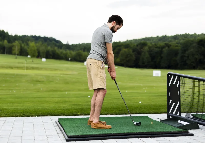 Doctor of Physical Therapy screening a golfer's hip and trunk rotation
